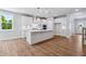 Bright kitchen showcases white cabinets, a center island and stainless steel appliances at 4002 Adler Cir, Buford, GA 30519