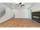 Open concept living room with modern fireplace, hardwood floors, and staircase at 4002 Adler Cir, Buford, GA 30519