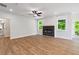Spacious living room with a modern fireplace, hardwood floors, and plenty of natural light at 4002 Adler Cir, Buford, GA 30519