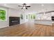 Bright open floor plan with modern fireplace, kitchen, and living room combination at 4002 Adler Cir, Buford, GA 30519