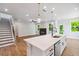 Open floor plan featuring hardwood floors, large island, and fireplace in the living room at 4002 Adler Cir, Buford, GA 30519