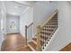Elegant staircase featuring wood treads and black iron spindles, adding a touch of sophistication to the home at 4002 Adler Cir, Buford, GA 30519