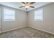Bright bedroom featuring neutral walls, carpet flooring, and two windows with blinds at 905 Fairburn Nw Rd, Atlanta, GA 30331