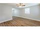 Spacious bedroom with wood-look flooring, ceiling fan, and window with blinds at 905 Fairburn Nw Rd, Atlanta, GA 30331