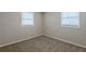 Simple bedroom with carpet flooring and two windows with blinds at 905 Fairburn Nw Rd, Atlanta, GA 30331