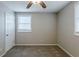 Well-lit bedroom with carpet flooring, a window with blinds, and a closet at 905 Fairburn Nw Rd, Atlanta, GA 30331