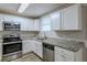 Modern kitchen with white cabinets, granite counters, and stainless steel appliances at 905 Fairburn Nw Rd, Atlanta, GA 30331
