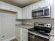 Updated kitchen boasts granite countertops and stainless steel appliances at 905 Fairburn Nw Rd, Atlanta, GA 30331