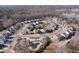 Aerial view of a residential neighborhood with winding streets and community pool surrounded by a wooded area at 5915 Partners Pass, Cumming, GA 30028
