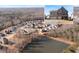 A picturesque aerial view showcases the community and pond, highlighting the prime real estate location of the home at 5915 Partners Pass, Cumming, GA 30028