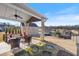 Spacious backyard with a covered patio, lush lawn, and a view of the surrounding neighborhood at 5915 Partners Pass, Cumming, GA 30028