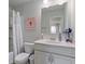 Bathroom featuring a white vanity, toilet, shower with tub and decorative pink wall hanging at 5915 Partners Pass, Cumming, GA 30028