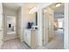 Bright bathroom featuring a large mirror and doorway to bedroom at 5915 Partners Pass, Cumming, GA 30028