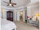 Spacious bedroom featuring trey ceiling with fan and access to upper level at 5915 Partners Pass, Cumming, GA 30028