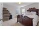 Bedroom featuring a luxurious, decorative, dark wood bed frame and neatly stacked boxes at 5915 Partners Pass, Cumming, GA 30028