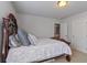 Bedroom with an ornate dark wood bed frame and a peek into the hallway at 5915 Partners Pass, Cumming, GA 30028