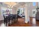 Beautiful dining room with hardwood floors, coffered ceilings, and open floor plan at 5915 Partners Pass, Cumming, GA 30028
