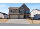 Traditional two-story home featuring an attached two-car garage at 5915 Partners Pass, Cumming, GA 30028