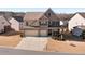 Two-story brick home with a three-car garage and manicured lawn at 5915 Partners Pass, Cumming, GA 30028