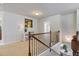 Hallway landing with decorative piano and natural lighting at 5915 Partners Pass, Cumming, GA 30028