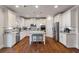 Spacious white kitchen with stainless steel appliances and center island with seating at 5915 Partners Pass, Cumming, GA 30028