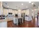 Bright kitchen with granite countertops, stainless steel appliances and a kitchen island with seating at 5915 Partners Pass, Cumming, GA 30028