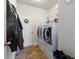 Well-equipped laundry room with modern washer and dryer, shelving, and ample storage space at 5915 Partners Pass, Cumming, GA 30028
