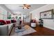 Spacious living room with hardwood floors that flows seamlessly into an open kitchen and dining area at 5915 Partners Pass, Cumming, GA 30028