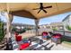 Covered patio with comfortable seating, a ceiling fan, and a fire pit for outdoor entertaining at 5915 Partners Pass, Cumming, GA 30028