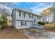 Gray two-story house with a driveway and landscaping at 2098 Mallard Crst, Lithonia, GA 30058