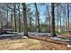 Wooded backyard with a deck and partial snow cover at 2751 Lloyd Rd, Decatur, GA 30034