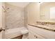 Renovated bathroom, granite countertop, marble-tiled shower at 2751 Lloyd Rd, Decatur, GA 30034