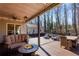 Relaxing deck with fire pit, seating area, and view of backyard at 221 Oakwood Dr, Cumming, GA 30040