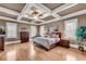 Spacious main bedroom with hardwood floors and coffered ceiling at 221 Oakwood Dr, Cumming, GA 30040