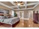 Main bedroom with hardwood floors, coffered ceiling, and ensuite bath at 221 Oakwood Dr, Cumming, GA 30040