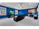 Media room features blue walls, a large TV, and comfortable seating at 221 Oakwood Dr, Cumming, GA 30040
