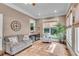 Sunroom with tiled floor, seating area, and large windows at 221 Oakwood Dr, Cumming, GA 30040