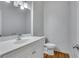 Updated bathroom with white vanity and hardwood floors at 225 Carlyle Park Ne Dr, Atlanta, GA 30307