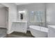 Bathroom boasts a soaking tub, updated vanity, and stylish flooring at 225 Carlyle Park Ne Dr, Atlanta, GA 30307