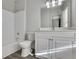 Clean bathroom with white vanity, tub shower combo, and gray floor at 225 Carlyle Park Ne Dr, Atlanta, GA 30307