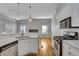 Open concept kitchen and living area with white cabinets and hardwood floors at 225 Carlyle Park Ne Dr, Atlanta, GA 30307