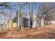 Fenced backyard with a partial view of the house surrounded by tall trees offering privacy at 4187 Mistymorn Way, Powder Springs, GA 30127