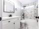 Modern bathroom featuring tiled shower and floor, plus a white vanity and black fixtures at 4187 Mistymorn Way, Powder Springs, GA 30127