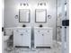 Bathroom featuring double vanity with black hardware and framed mirrors, with a tiled shower in the background at 4187 Mistymorn Way, Powder Springs, GA 30127