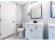 Bright bathroom featuring a modern vanity and toilet with a black faucet and hardware at 4187 Mistymorn Way, Powder Springs, GA 30127