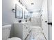 Bathroom with double sink vanity, framed mirrors, tiled shower, and modern fixtures at 4187 Mistymorn Way, Powder Springs, GA 30127