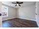 A cozy bedroom showcasing wood flooring and natural light at 4187 Mistymorn Way, Powder Springs, GA 30127