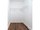 Walk-in closet with wire shelving and wood-look floors and neutral walls at 4187 Mistymorn Way, Powder Springs, GA 30127