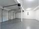 Garage with white walls and gray epoxy floors at 4187 Mistymorn Way, Powder Springs, GA 30127