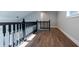 Upstairs hallway with decorative railing and beautiful flooring at 4187 Mistymorn Way, Powder Springs, GA 30127